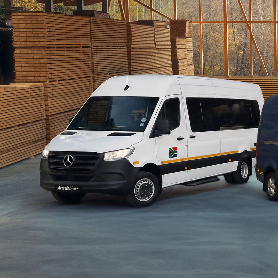 The Mercedes-Benz Sprinter as a Platform and Panel Van stand next to one another in front of a modern office complex.