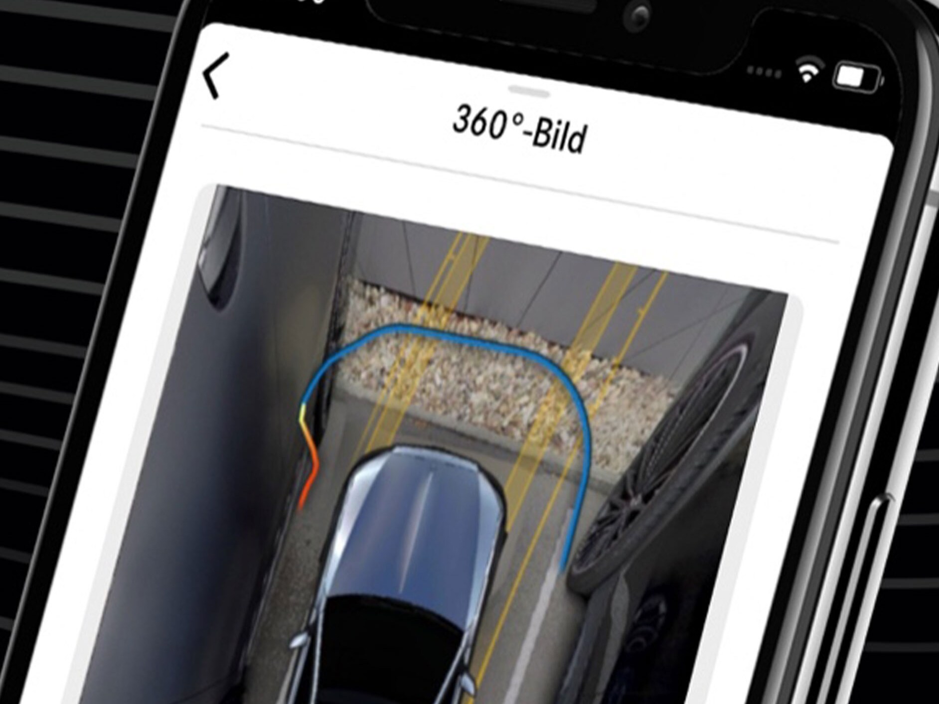 A Mercedes-Benz conveniently steered into a tight parking space using the Mercede-Benz Remote Parking Assist App and the 360° view on a smartphone.