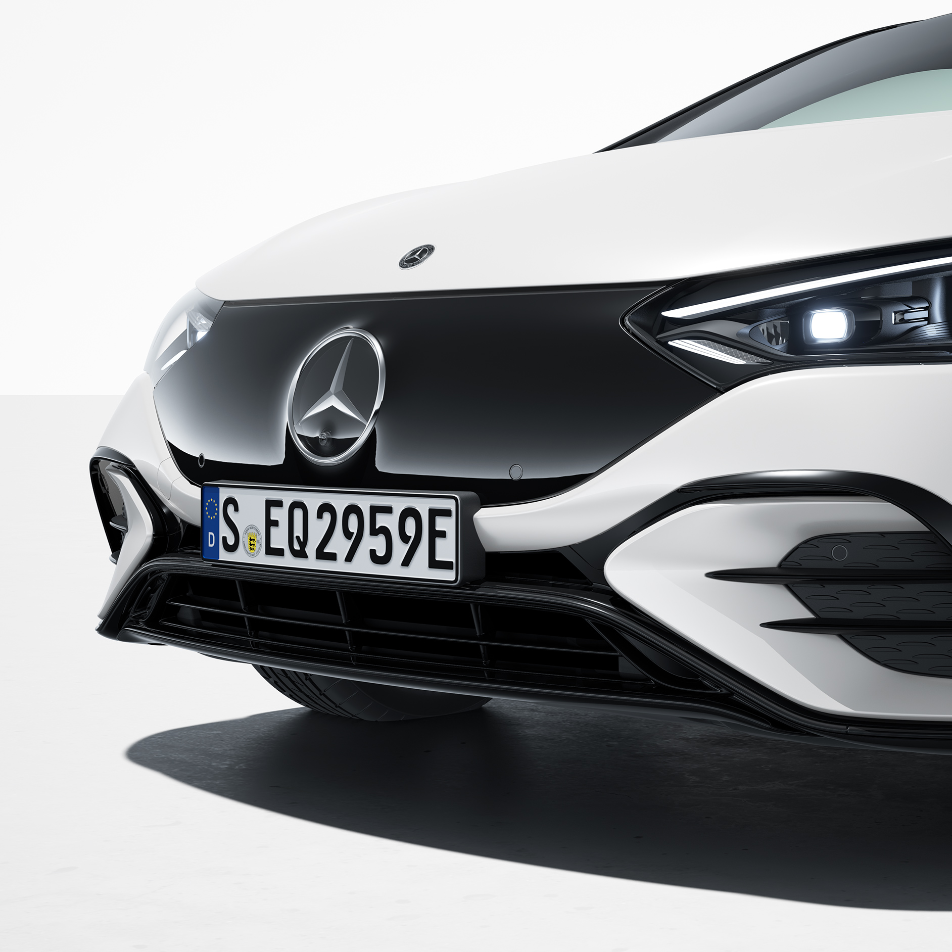 Premium package | EQE Saloon | Mercedes EQ The EQE Saloon by Mercedes-EQ from a frontal side view.