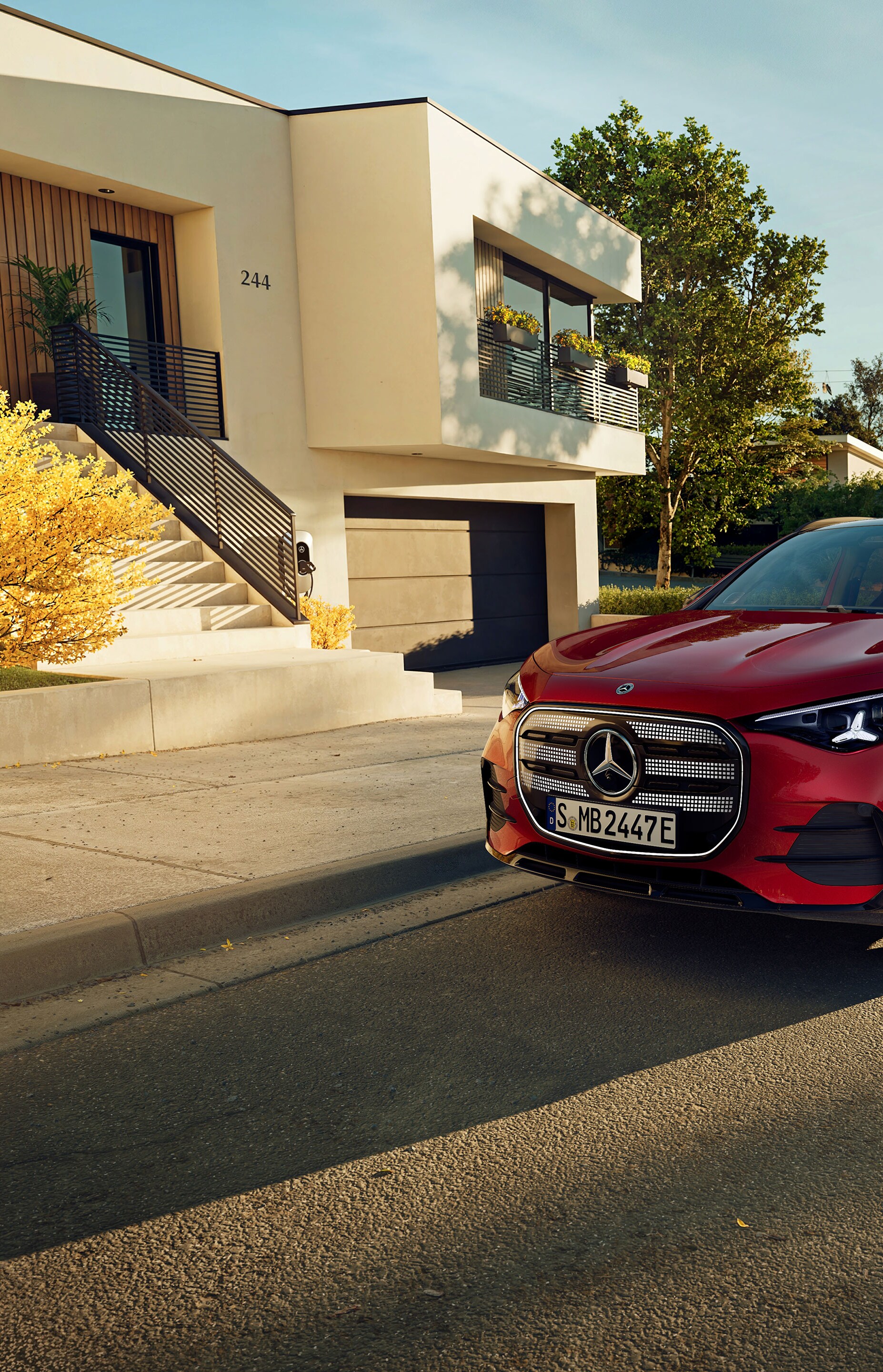 The all-new electric GLA from Mercedes-Benz parking in a parking space next to a coffee shop.