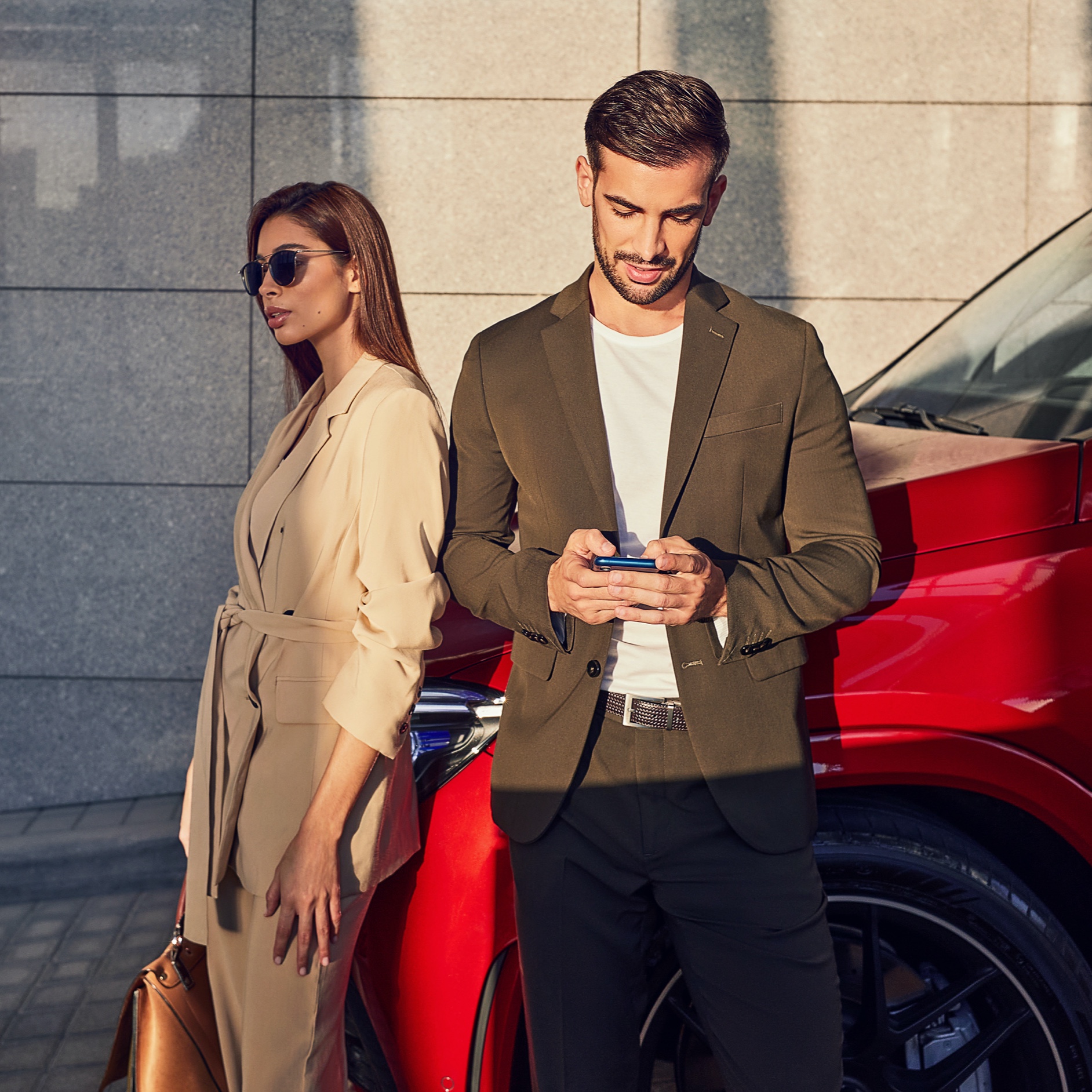 Two people renew/purchase Digital Extras for a vehicle via smartphone. Two people renew/purchase Digital Extras for a vehicle via smartphone.