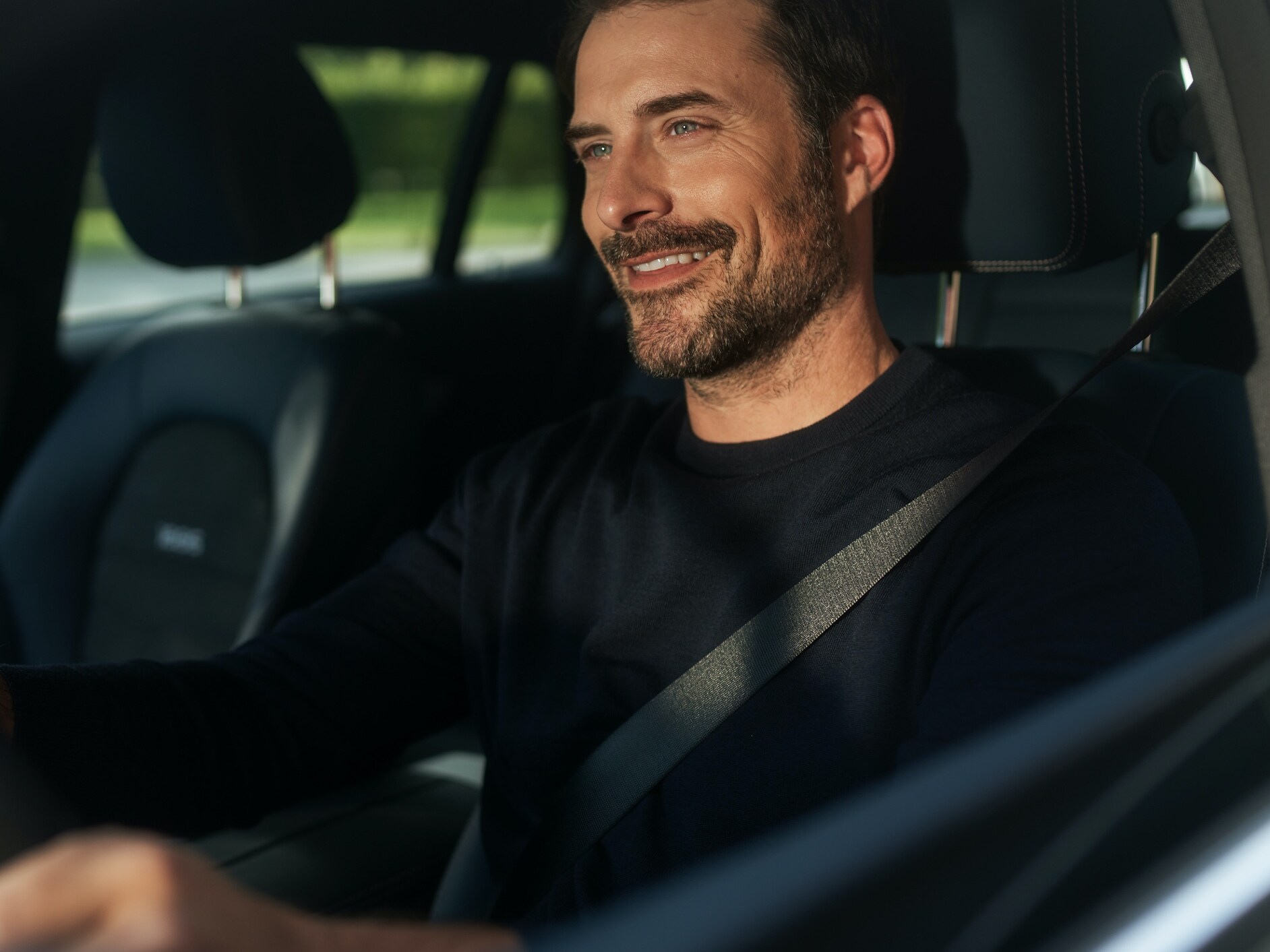 A man uses the MBUX Voice Assistant in his vehicle.