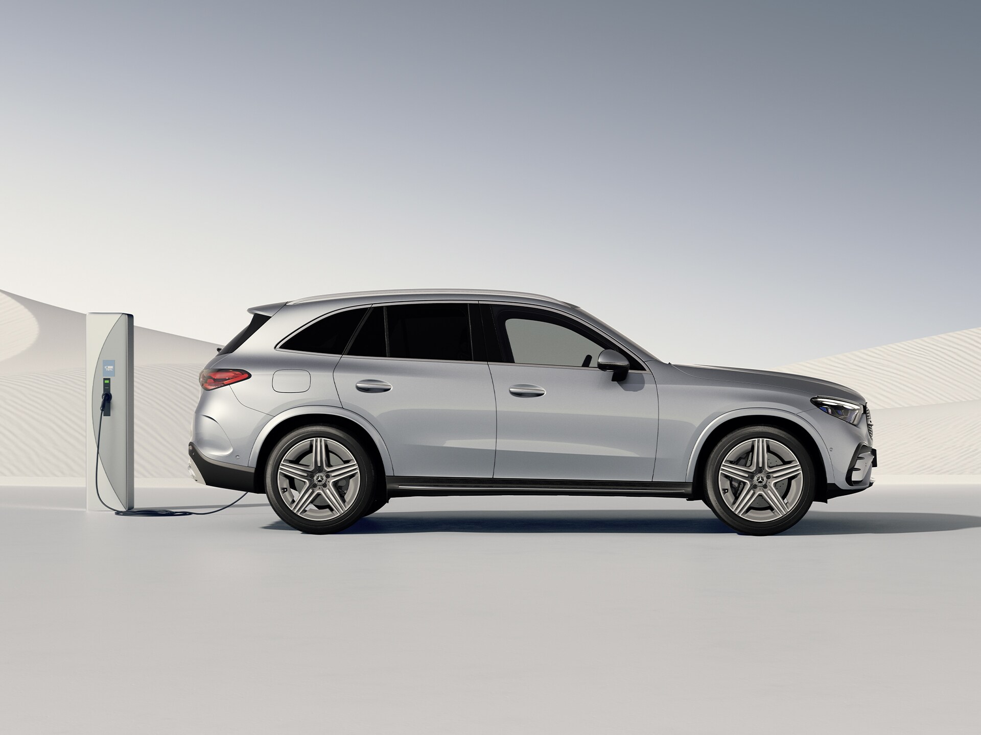 Side view of the GLC plug-in hybrid SUV at a charging station.