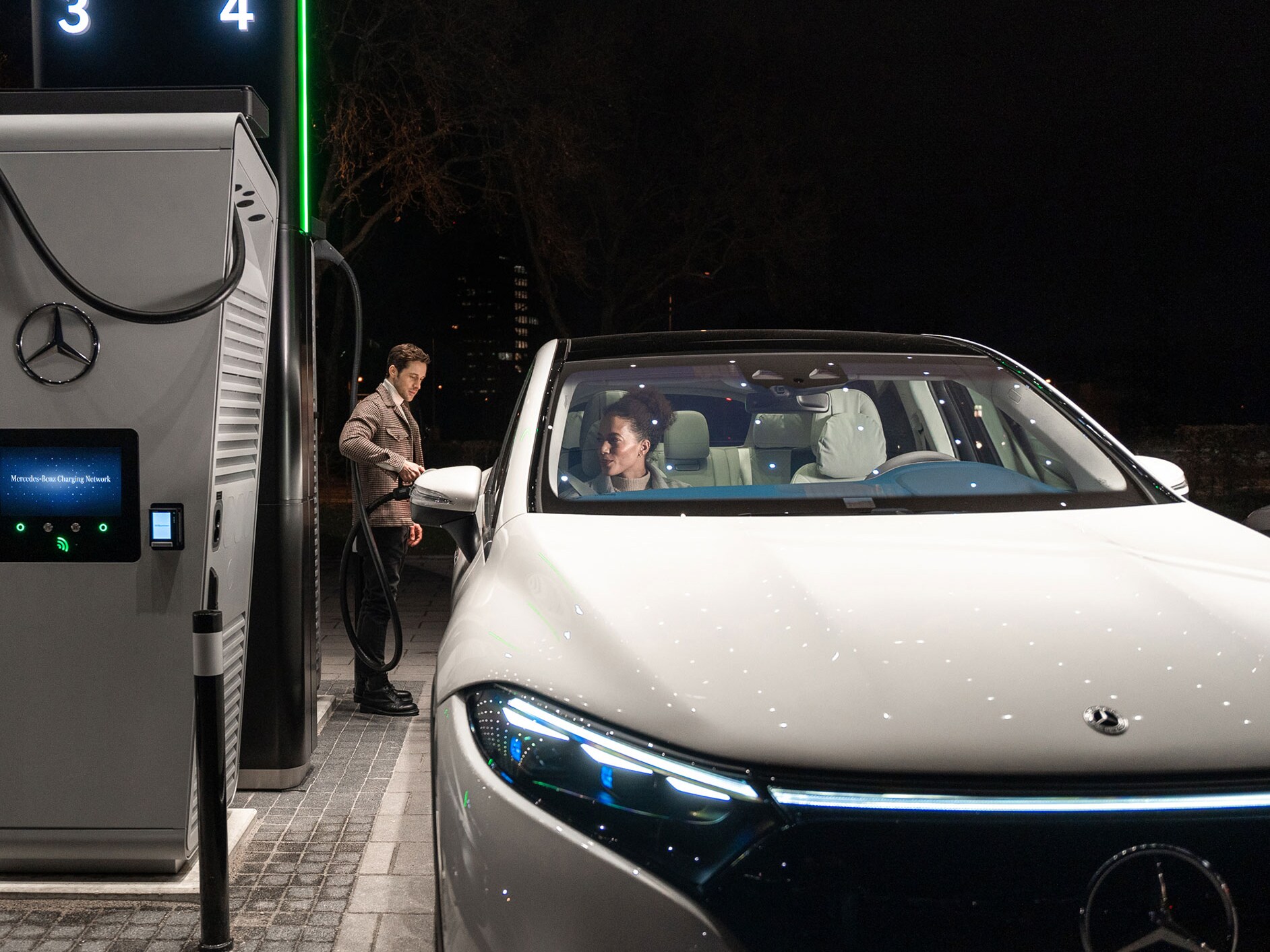 The Mercedes-Benz CLA standing on a street, connected to a charging station.