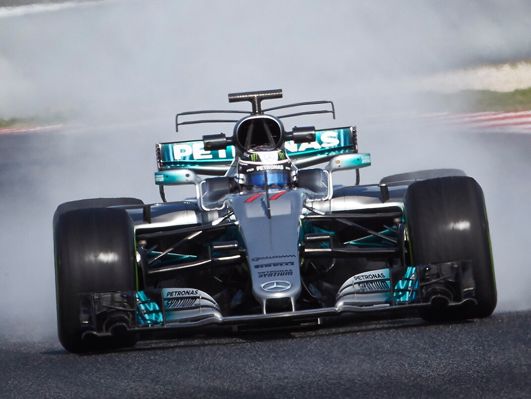 The image shows a Formula 1 car from the front on a race track.