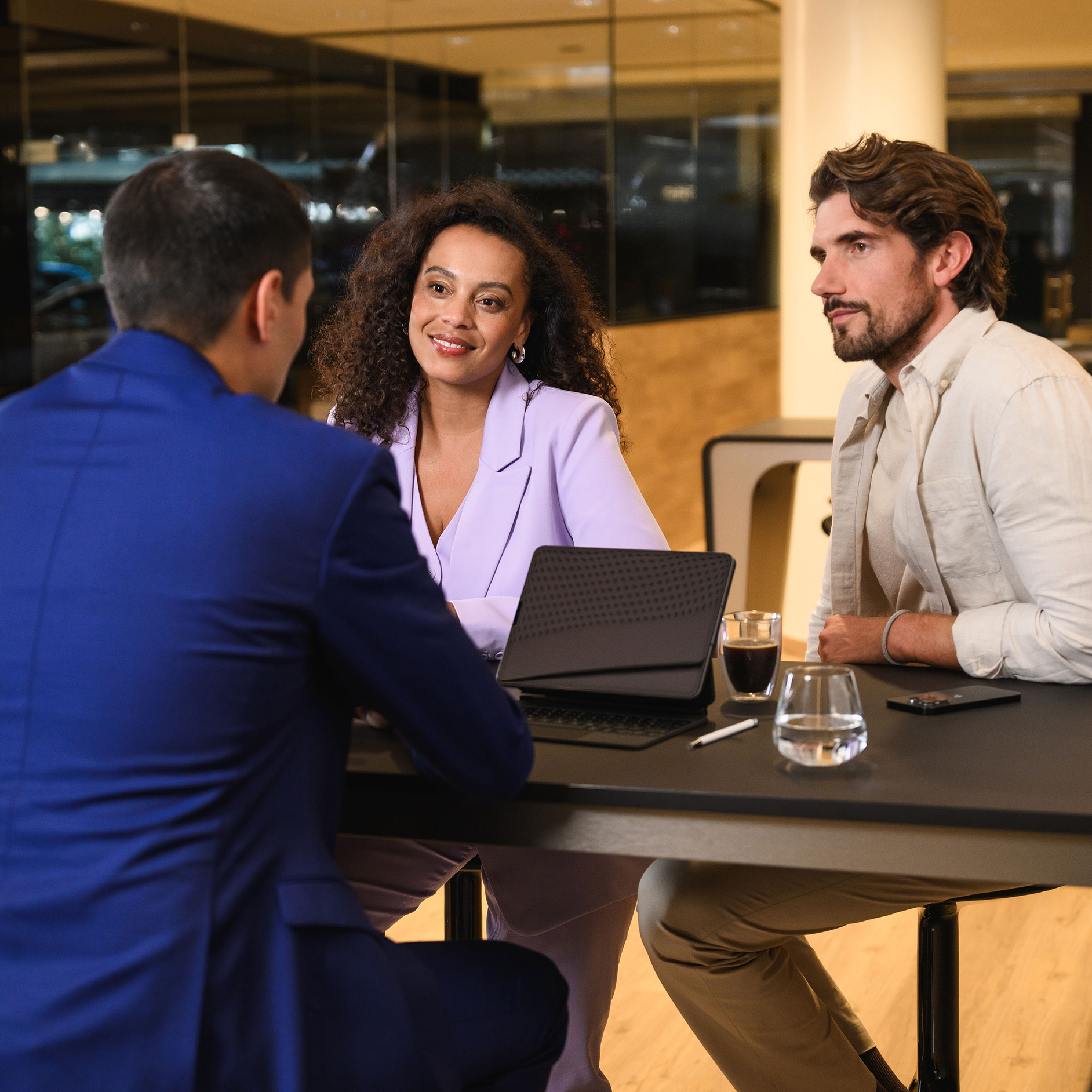 Finance offer for your Mercedes-Benz Three people sitting on a table engaging in a discussion.