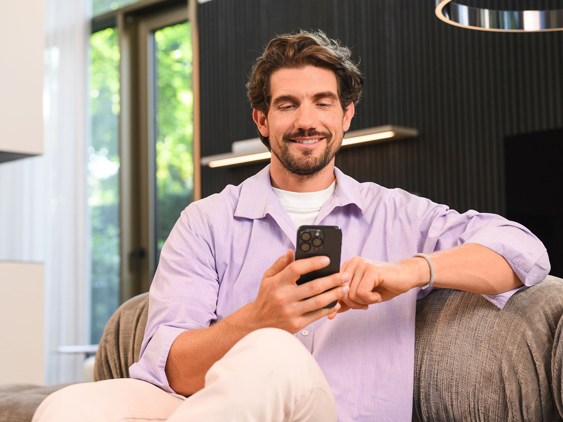 A person sitting and using a mobile device.
