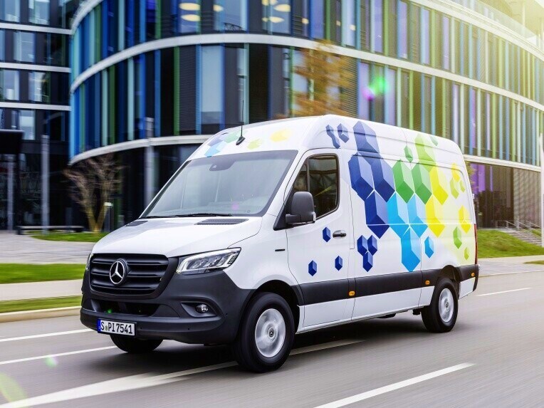 An eSprinter Panel Van, a Mercedes-Benz electric van, in movement in an urban landscape.